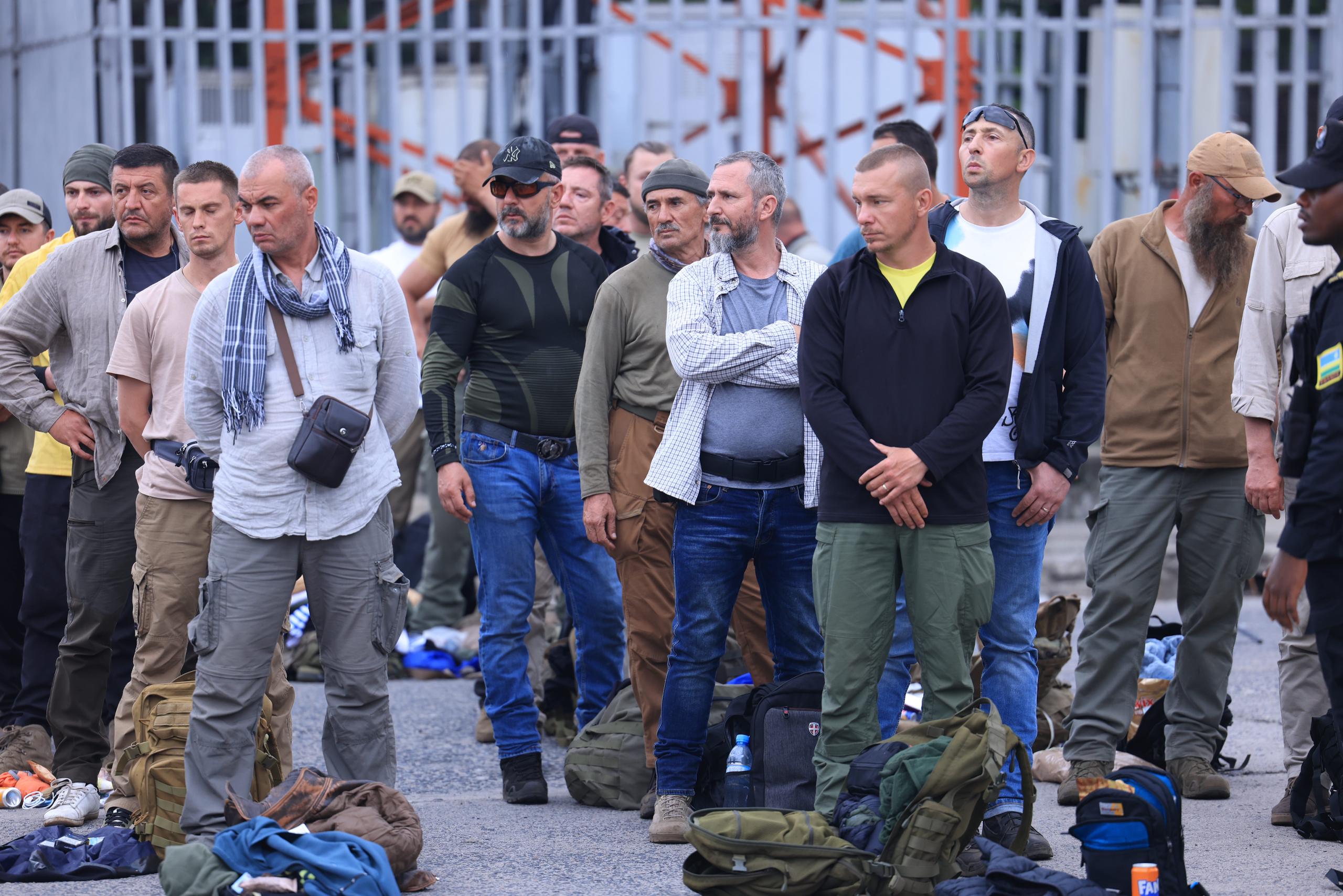 European mercenaries at the DRC-Rwanda border are waiting to be inspected before entering Rwanda. Many of them are from Romania.